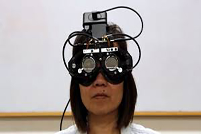 girl wearing a headset over eyes to monitor eye tracking